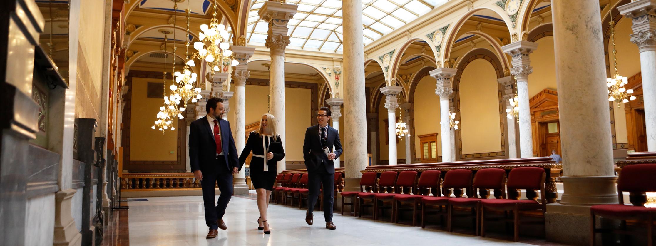 people walking down a beautiful hallway